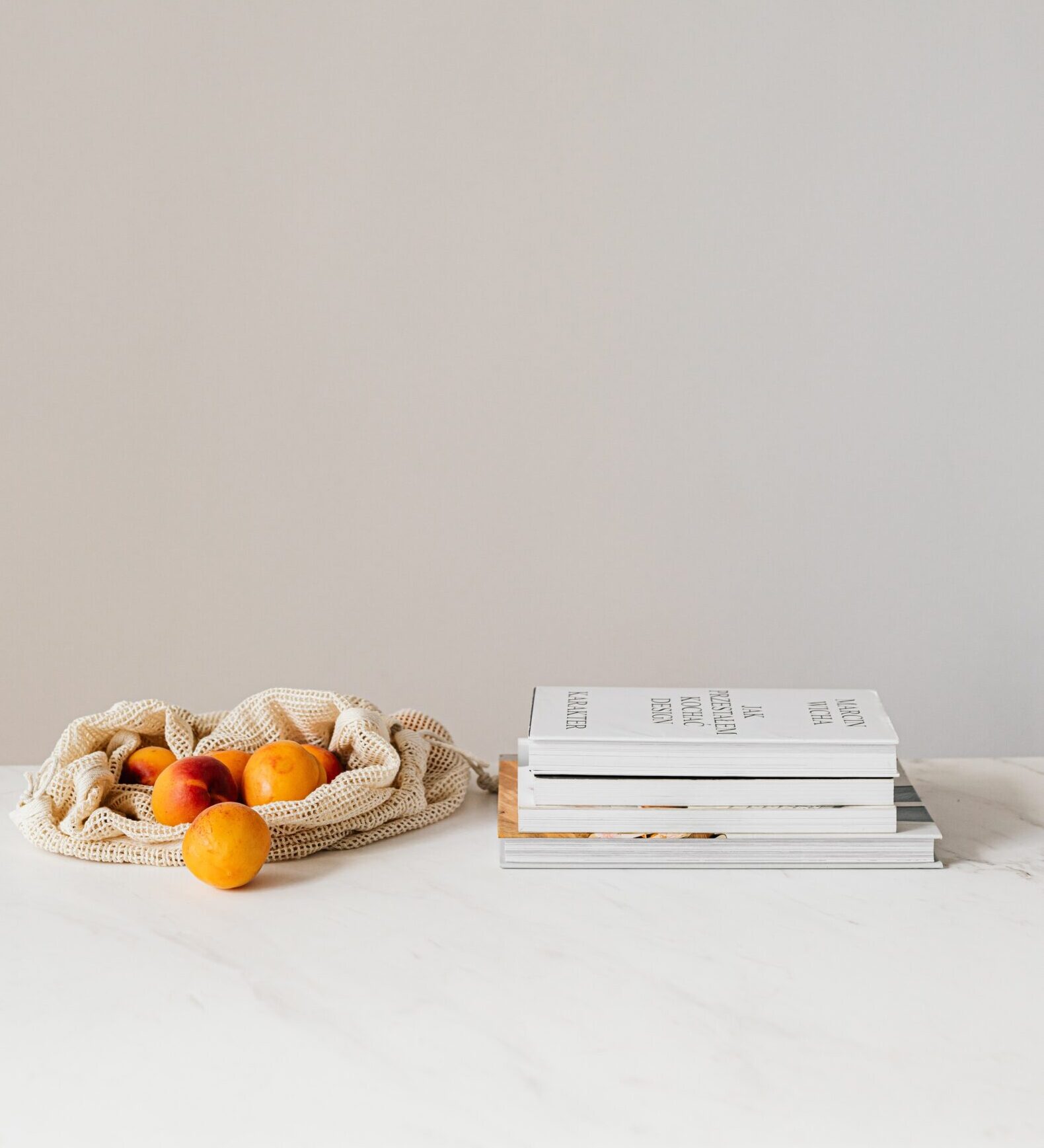 Minimal flat lay with books and fruit, symbolising privacy and calm in confidentiality eating disorder recovery.